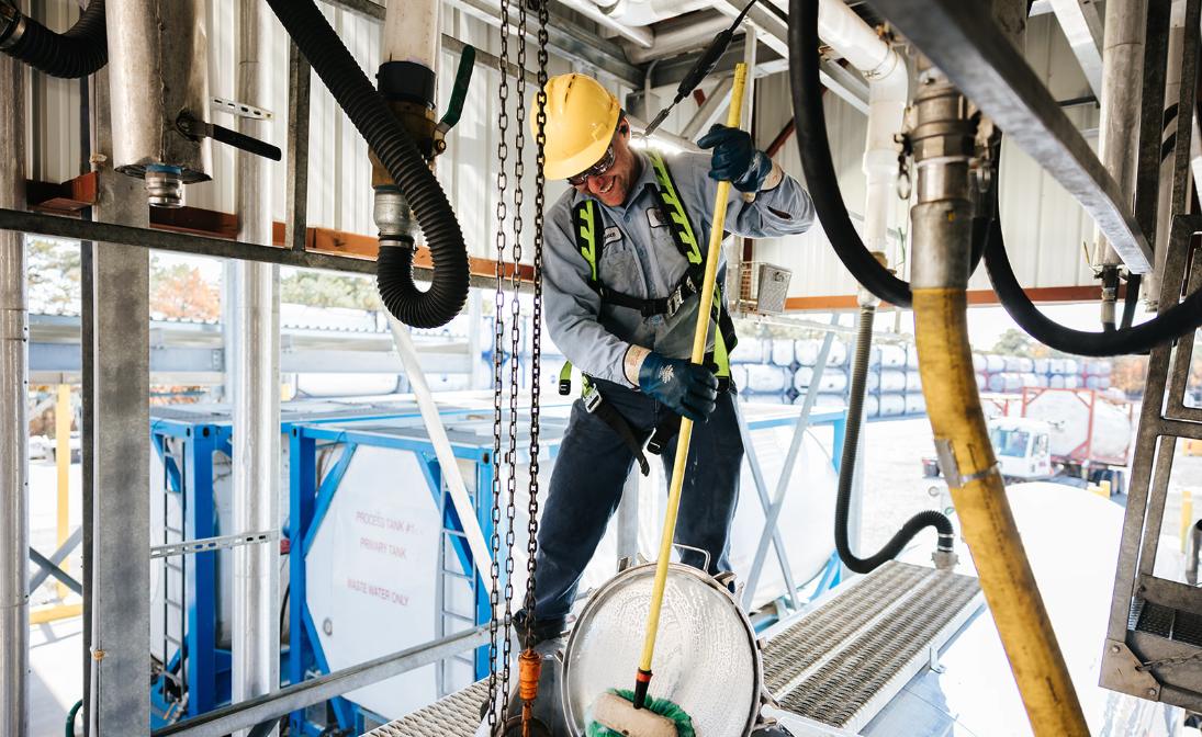 all-chem-team-member-cleaning-tank