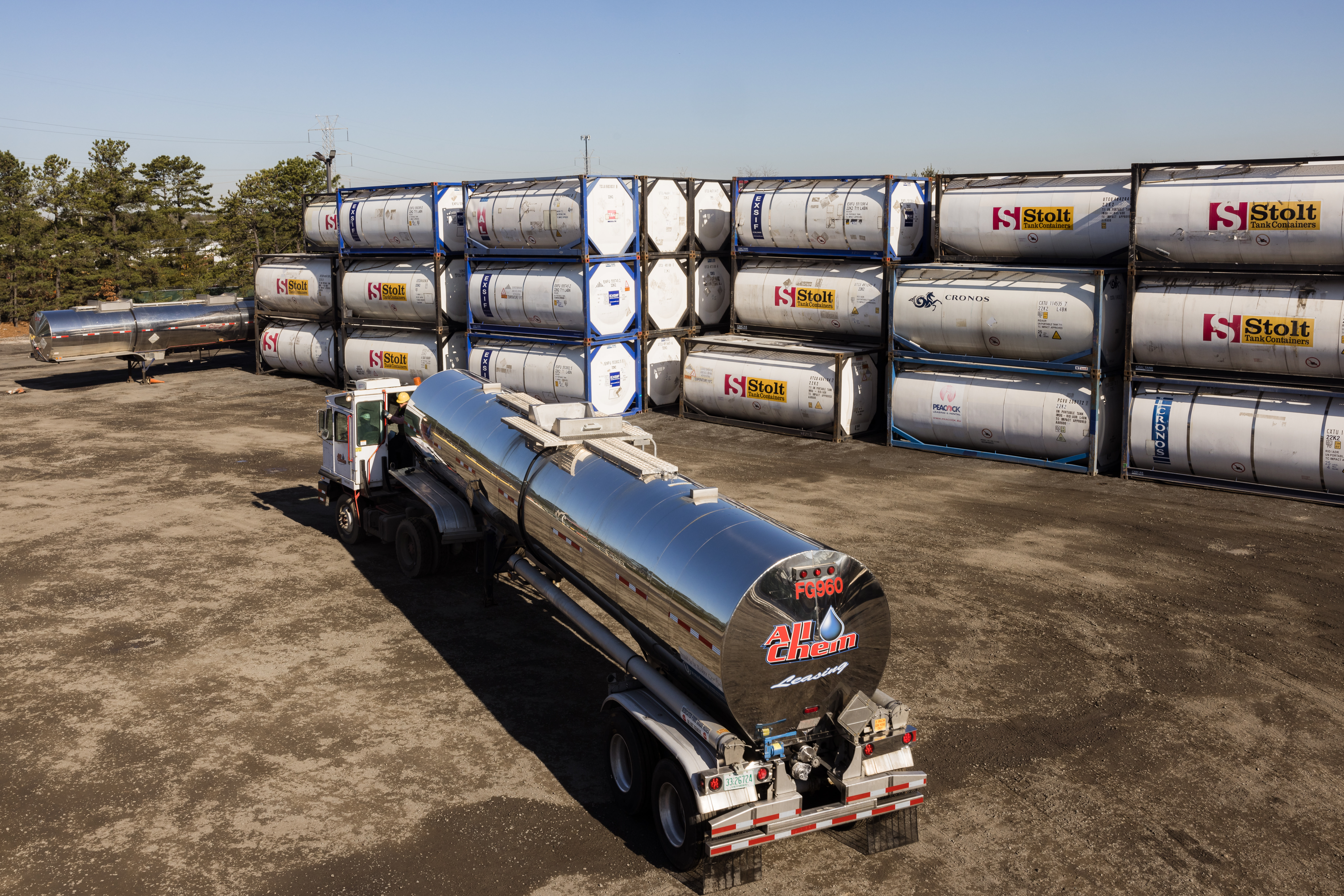 all-chem-truck-driving-past-iso-container-stacks