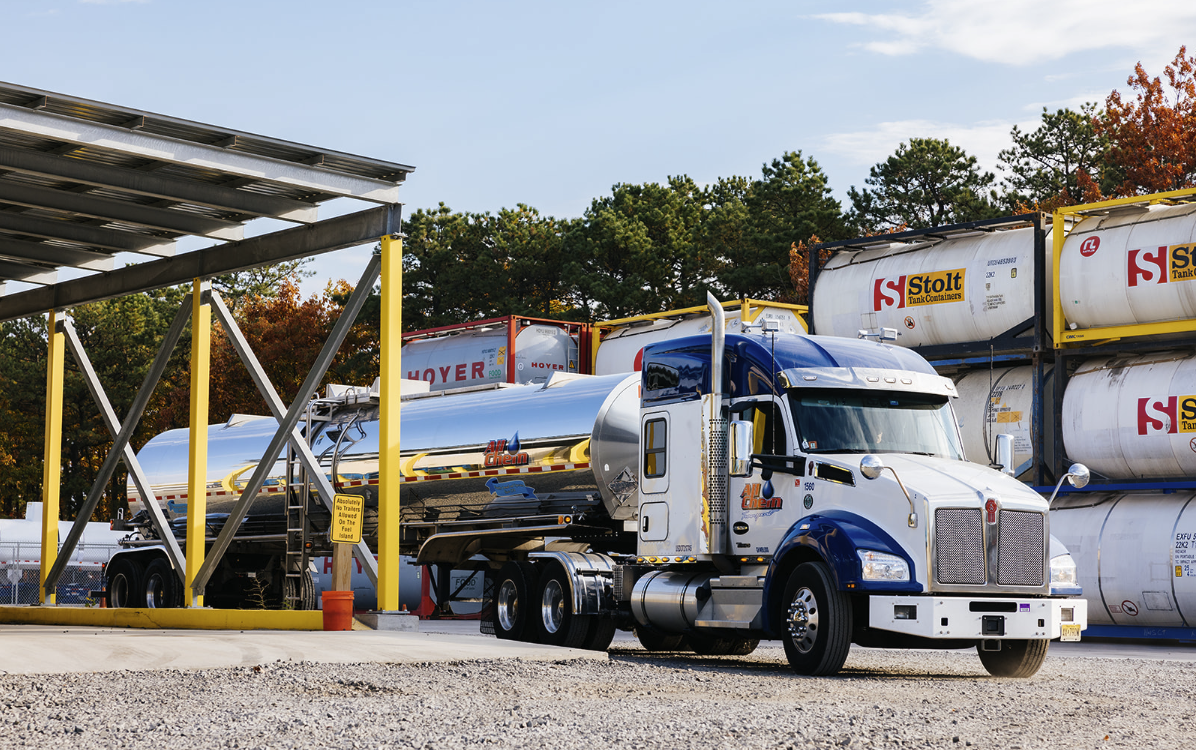 all-chem-truck-driving-past-iso-containers